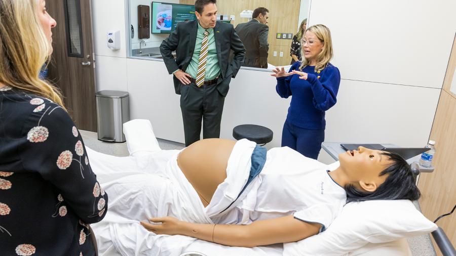Faculty learn about a high-fidelity manikin that simulates pregnancy