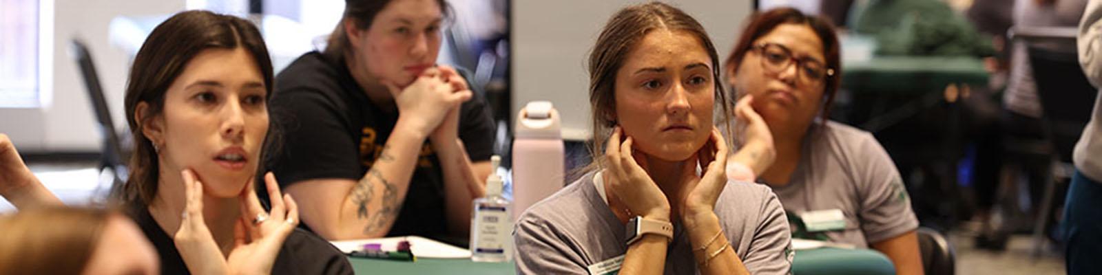 Occupational therapy students listening to a lecture during a lab.